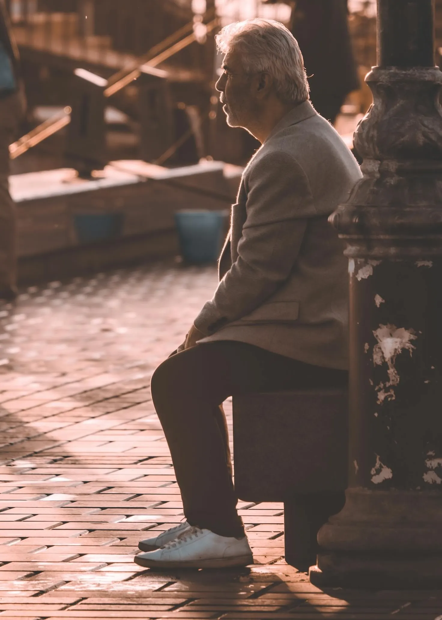 Older man sitting thoughtfully in warm evening light